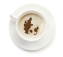 Cup of coffee with foam and powder in the shape of Denmark.(seri