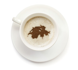 Obraz premium Cup of coffee with foam and powder in the shape of Switzerland.(