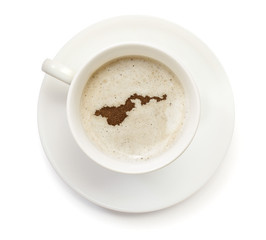 Cup of coffee with foam and powder in the shape of American Samo