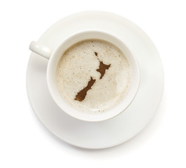 Cup of coffee with foam and powder in the shape of New Zealand.(