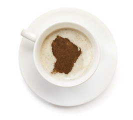 Cup of coffee with foam and powder in the shape of French Guiana