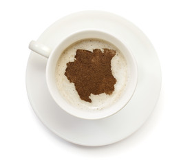 Cup of coffee with foam and powder in the shape of Suriname.(ser