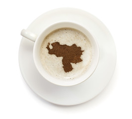 Cup of coffee with foam and powder in the shape of Venezuela.(se