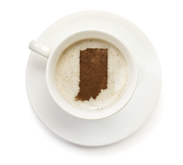 Cup of coffee with foam and powder in the shape of Indiana.(seri