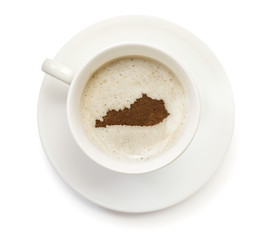 Cup of coffee with foam and powder in the shape of Kentucky.(ser
