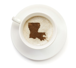 Cup of coffee with foam and powder in the shape of Louisiana.(se
