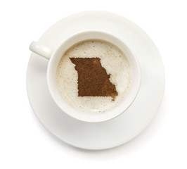 Cup of coffee with foam and powder in the shape of Missouri.(ser