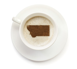Cup of coffee with foam and powder in the shape of Montana.(seri