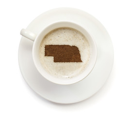 Cup of coffee with foam and powder in the shape of Nebraska.(ser