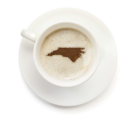 Cup of coffee with foam and powder in the shape of North Carolin