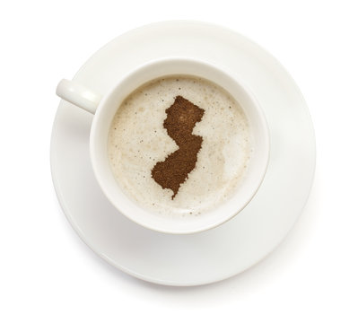 Cup of coffee with foam and powder in the shape of New Jersey.(s