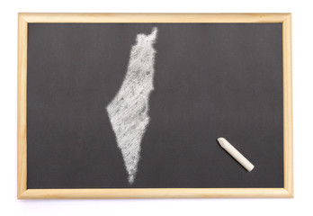 Blackboard with a chalk and the shape of Israel drawn onto. (ser