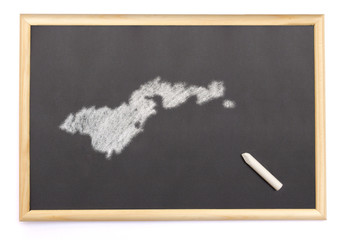 Blackboard with a chalk and the shape of American Samoa drawn on