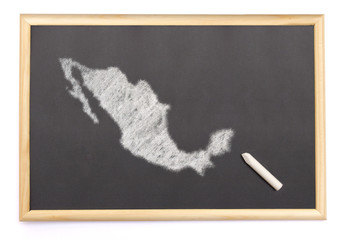 Blackboard with a chalk and the shape of Mexico drawn onto. (ser