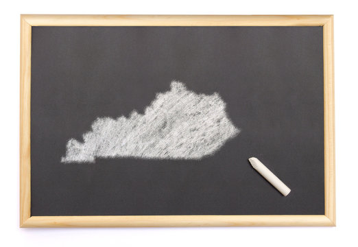Blackboard with a chalk and the shape of Kentucky drawn onto. (s