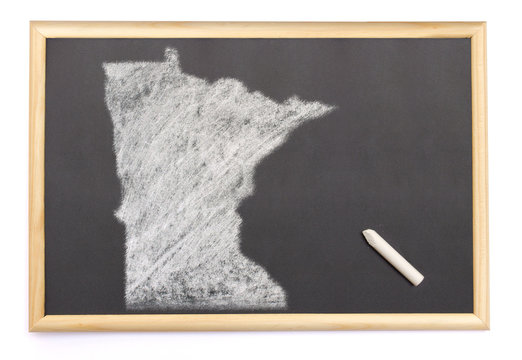 Blackboard with a chalk and the shape of Minnesota drawn onto. (