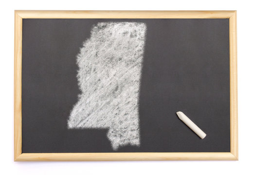 Blackboard with a chalk and the shape of Mississippi drawn onto.