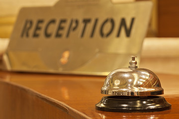 old hotel bell on a wood stand - obrazy, fototapety, plakaty