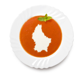 Plate tomato soup with cream in the shape of Luxembourg.(series)
