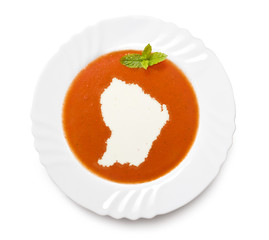 Plate tomato soup with cream in the shape of French Guiana.(seri