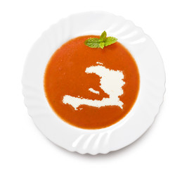 Plate tomato soup with cream in the shape of Haiti.(series)