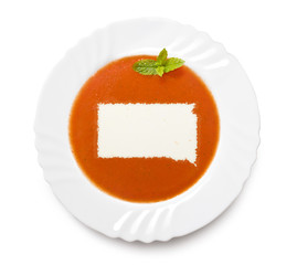 Plate tomato soup with cream in the shape of South Dakota.(serie
