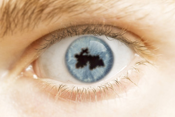 Naklejka premium Close-up of an eye with the pupil in the shape of Tajikistan.(se