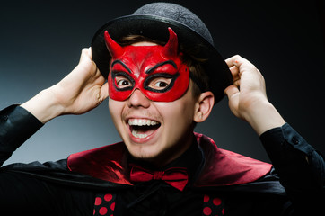 Funny devil against dark background
