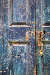 Old wooden blue door with padlocks