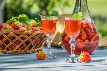 Homemade strawberry liqueur served in the garden