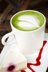 close up hot green tea and milk cream in white cup