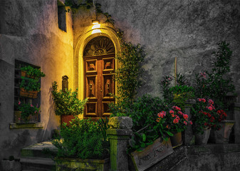 Fototapeta na wymiar Door in an old house decorated with flower at night