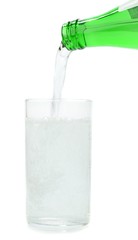 Mineral water being poured from a bottle into a glass