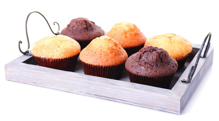 Tasty muffins on wooden tray isolated on white