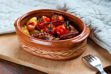 Octopus baked with tomatoes and potatoes
