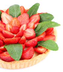 Strawberry tart with green mint leaves isolated on white