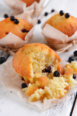 Tasty cupcakes with blueberries on table close-up
