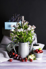 Still life with flowers and fruits on dark background