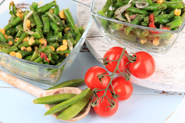 Salad with green beans, ham and  corn in glass bowls,