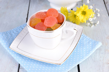 Jelly candies in cup on table close-up