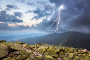 thunderstorm with lightening and dramatic clouds in mountains