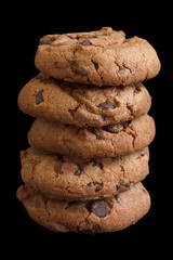 Stack of chocolate chip cookies isolated on black.