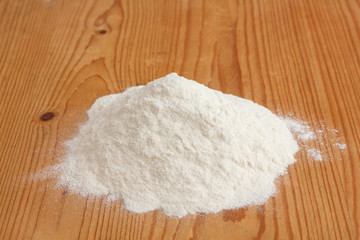 White flour on a rustic old kitchen board.