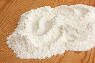 White flour on a rustic old kitchen board.