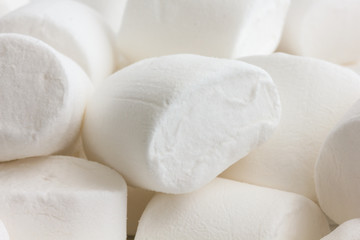 Fototapeta na wymiar Detail white marshmallows. Randomly arranged.
