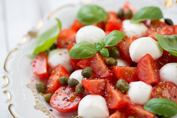 Close-up of caprese salad with capers, horizontal shot