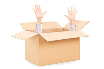 Hands arising from a carton box symbolizing surrender