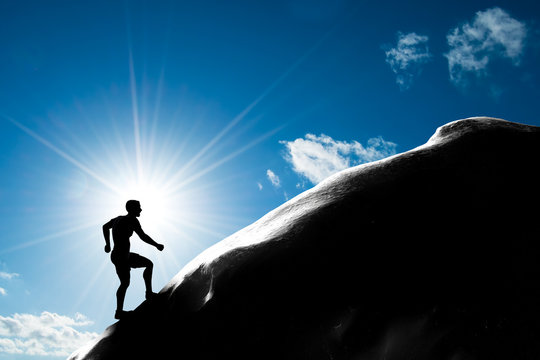 Man Running Up Hill To The Peak Of The Mountain. Trekking,