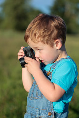 Little child taking pictures outdoor