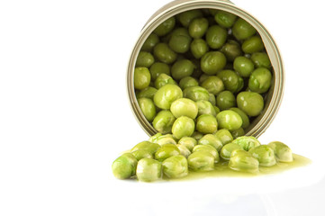Green peas in a tin can over white background